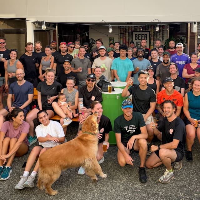 Beer Jerk Run Club group photo outside Small Gods with a dog in front.